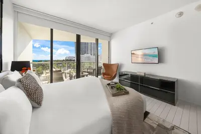 a hotel room with a large bed and a large window at Ocean View Residence at South Beach -514 in Miami Beach