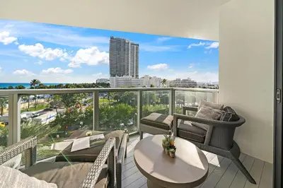 a balcony with a table and chairs and a view of the city at Ocean View Residence at South Beach -514 in Miami Beach