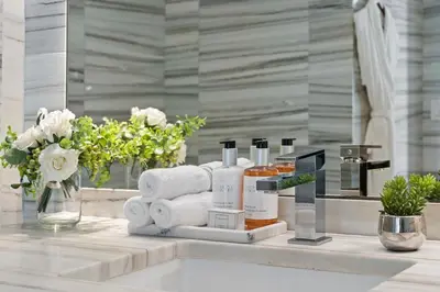 a bathroom counter with towels and products on a table at Ocean View Residence at South Beach -514 in Miami Beach