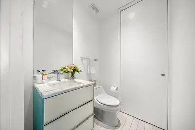 a white bathroom with a toilet and a sink at Ocean View Residence at South Beach -514 in Miami Beach