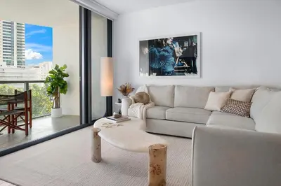 a white living room with a couch and a table at Ocean View Residence at South Beach -514 in Miami Beach