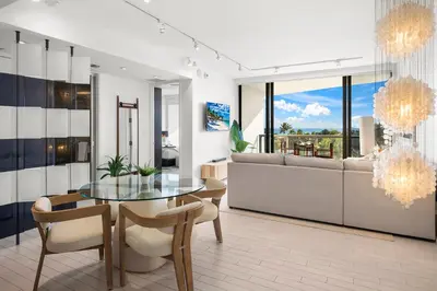 a dining room with a glass table and a couch at Ocean View Residence at South Beach -514 in Miami Beach
