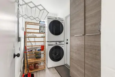 a laundry room with two washer and dryer at Lauderdale Modern 1 Bedroom 1 Bathroom with Private Backyard in Fort Lauderdale