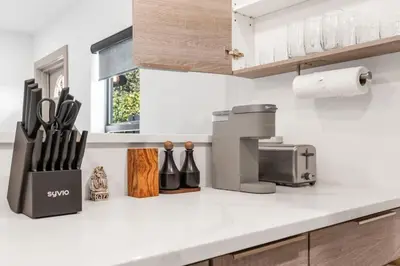 a kitchen counter with a knife block and a coffee maker at Lauderdale Modern 1 Bedroom 1 Bathroom with Private Backyard in Fort Lauderdale