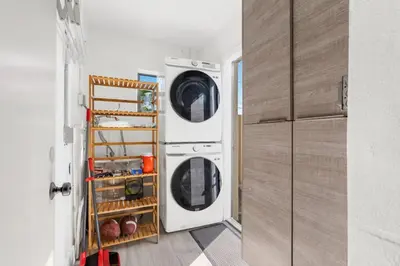 a laundry room with two washer and dryer at Lauderdale Modern 1 Bedroom 1 Bathroom with Private Backyard in Fort Lauderdale