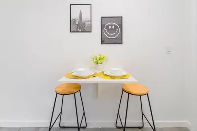 a white table with two stools in a room at Lovely Studio A Few Steps From The Beach in Miami