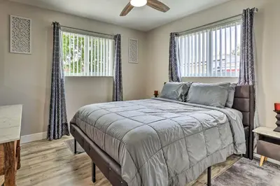 a bedroom with a bed and two windows at Gated Southern Miami Home 22 Mi to Downtown! in Miami