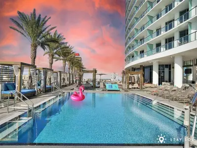 a large swimming pool with a pink inflatable raft at Ocean View Balcony Beachfront Resort Amazing Pools in Hollywood