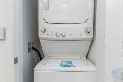 a white washing machine with a blue item on it at Ocean View Balcony Beachfront Resort Amazing Pools in Hollywood