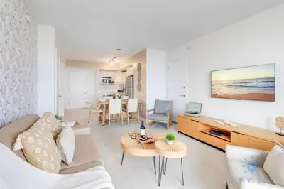 a living room with a couch and a table at Pool - Apartment with Balcony - Gym - Near Beach in Hallandale Beach