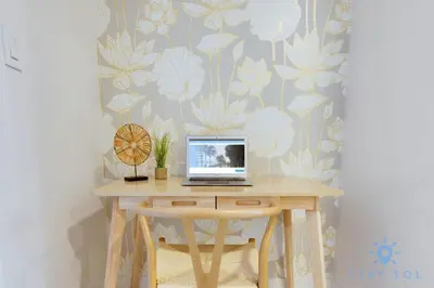 a laptop computer sitting on a wooden table in a room at Pool - Apartment with Balcony - Gym - Near Beach in Hallandale Beach