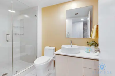 a bathroom with a toilet and a sink and a shower at Pool - Apartment with Balcony - Gym - Near Beach in Hallandale Beach