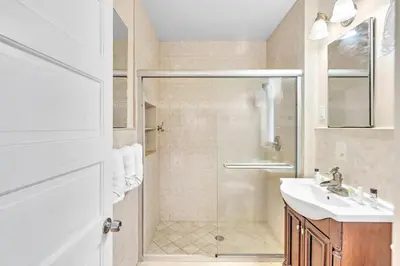 a white bathroom with a shower and a sink at Sea Angel in Hollywood Beach
