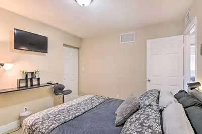 a bedroom with a bed and a flat screen tv at Fort Lauderdale Apt Near Beaches and Shopping! in Fort Lauderdale