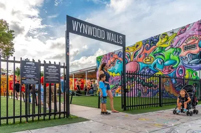 a group of children standing in front of a mural at Intimate Casita Mia minutes away from Airport, Calle 8, Brickell, Coral Gables, The beach and more! in Miami