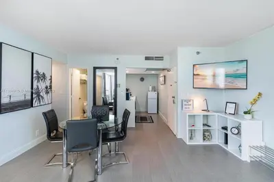 a dining room and living room with a table and chairs at 11th Miami Beach - Ocean View -Free Valet Parking in Miami Beach