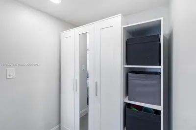 a white closet with a mirror in a room at 11th Miami Beach - Ocean View -Free Valet Parking in Miami Beach
