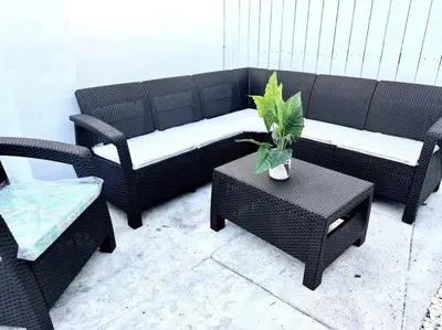 a black couch and chairs and a table with a plant at Lush tropical big home close to Airport, Calle 8, Coral Gables and lots more Miami amenities in Miami