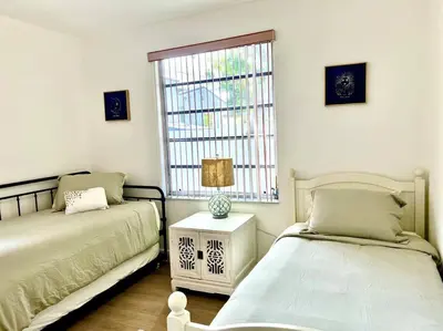 a bedroom with two beds and a window at Lush tropical big home close to Airport, Calle 8, Coral Gables and lots more Miami amenities in Miami