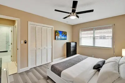 a bedroom with a bed and a ceiling fan at Deluxe 5BR Villa Heated Pool near Hollywood Beach in Hollywood