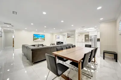 a dining room with a table and a couch at Premium Luxury 5BR Villa near Hollywood Beach in Hollywood