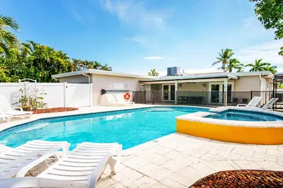 a swimming pool with chairs and a house at Premium Luxury 5BR Villa near Hollywood Beach in Hollywood