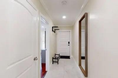 a hallway with a white door and a mirror at Premium Luxury 5BR Villa near Hollywood Beach in Hollywood