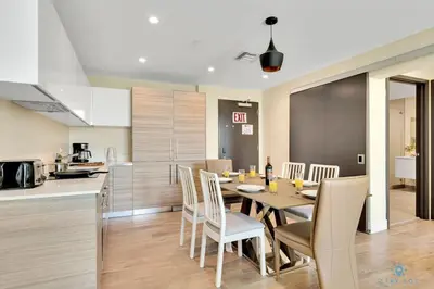 a kitchen and dining room with a table and chairs at Front Bay View Terrace Rooftop Pool Near Beach in Hollywood