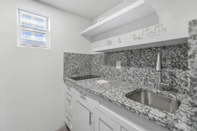 a white kitchen with a sink and a window at Beachfront Getaway Studio with Parking - M21 in Hollywood