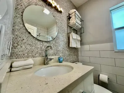 a bathroom with a sink and a mirror at Las Olas 1BR Pool Free Parking Ideal for 2 in Fort Lauderdale