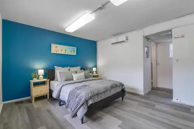 a bedroom with a blue wall and a bed at The mariner Suites #22 - Beachfront Studio in Hollywood