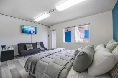 a bedroom with a bed and a couch and a tv at The mariner Suites #22 - Beachfront Studio in Hollywood