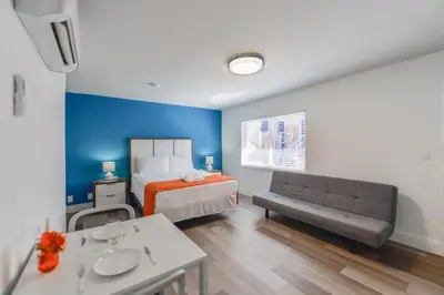 a bedroom with a bed and a blue wall at Hollywood Beach Retreat Studio - M23 in Hollywood