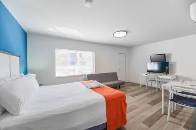 a bedroom with a bed and a couch and a table at Hollywood Beach Retreat Studio - M23 in Hollywood