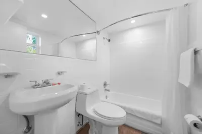 a white bathroom with a toilet and a sink at Beachfront Studio with Pool access -M24 in Hollywood