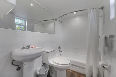 a white bathroom with a sink and a toilet at Family Friendly Beach Escape with pool and parking - M41 in Hollywood