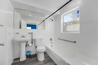 a white bathroom with a sink and a toilet at Radiant Unit with parking and pool - M26 in Hollywood
