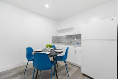a kitchen with a table and chairs and a refrigerator at Radiant Unit with parking and pool - M26 in Hollywood