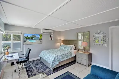 a bedroom with a bed and a desk and a chair at Walk to Las Olas Pool Perfect Couples Stay in Fort Lauderdale