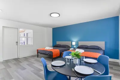 a room with a table and chairs and a blue wall at Spacious Oceanfront Studio with pool access - M27 in Hollywood