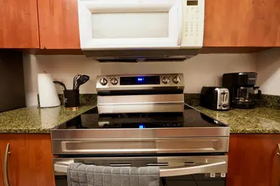 a kitchen with a stove and a microwave at City & Sea View+FREE Parking Modern Condo in Miami