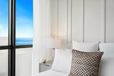 a bedroom with a bed with a view of the ocean at Private Residence at South Beach - 811 in Miami Beach