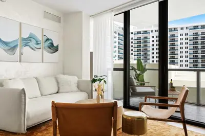 a living room with a couch and a table at Private Residence at South Beach - 811 in Miami Beach