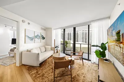 a living room with a couch and a table at Private Residence at South Beach - 811 in Miami Beach