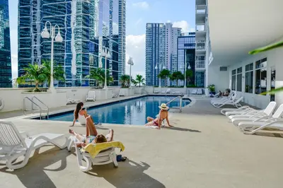 a group of people playing in the pool at a hotel at Centric 40thFloor Brickell Condo FREE parking by Palermo Home Miami in Miami