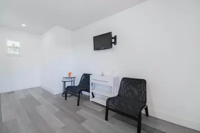 a room with two chairs and a desk and a tv at Serene Studio by the Beach with pool - M34 in Hollywood