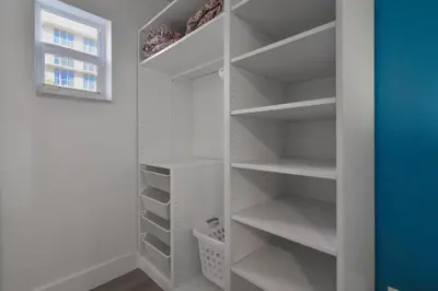 a walk in closet with white shelves and a window at Serene Studio by the Beach with pool - M34 in Hollywood