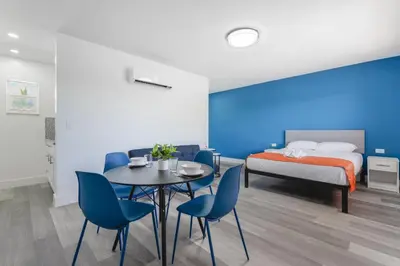 a bedroom with a bed and a table and chairs at Amazing unit with pool & parking at the beach - M35 in Hollywood