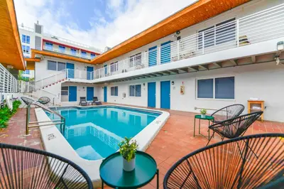 a patio with a swimming pool and chairs at Amazing unit with pool & parking at the beach - M35 in Hollywood