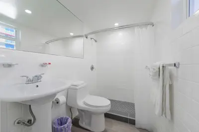 a white bathroom with a sink and a toilet at Amazing unit with pool & parking at the beach - M35 in Hollywood